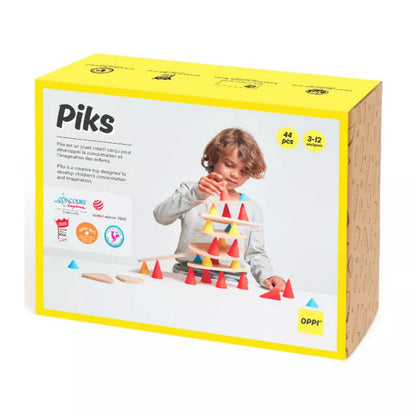 A box with a child playing with Piks Construction Medium Kit.