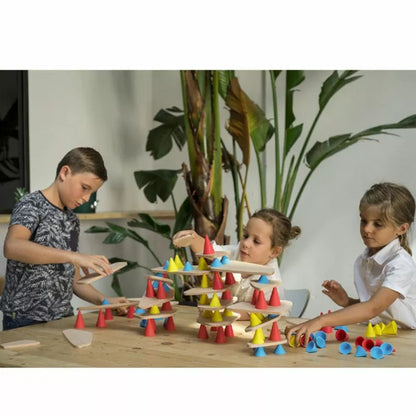 A group of children playing with Piks Construction Education Kit, engaging in a construction game at a table.