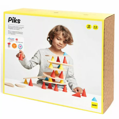 A child is playing with the Piks Construction Education Kit in a box.