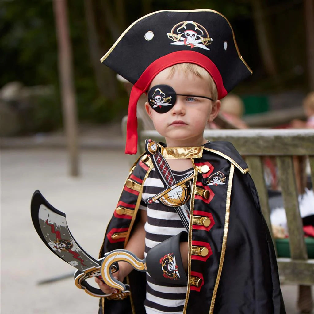 A little boy in a Liontouch Pirate Cape Captain Cross costume with a dress-up accessory.