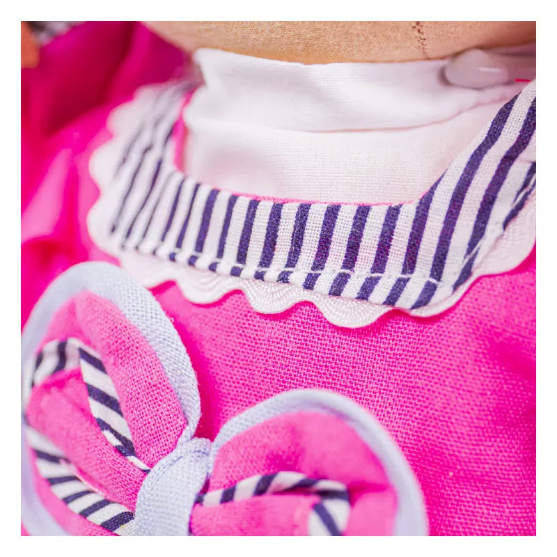 A close up of a child's shirt with a Bigjigs Emma Doll Large bow tie.