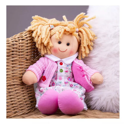 A Bigjigs Poppy Doll Small with blonde hair sitting on a wicker chair.