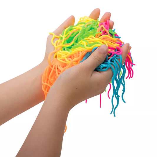 Hands holding a vibrant tangle of neon-colored Ramen Noodlies NeeDoh, a non-toxic fidget toy, against a white background.