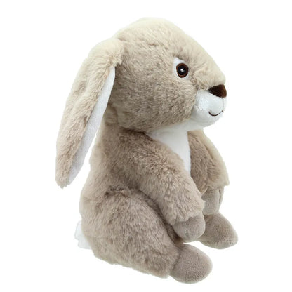 Rosie the Rabbit ECO Cuddlies is a soft, plush bunny with light brown fur, a white belly, large floppy ears, and an embroidered face. Crafted from recycled materials by Wilberry, she sits upright and looks cuddly and gentle.