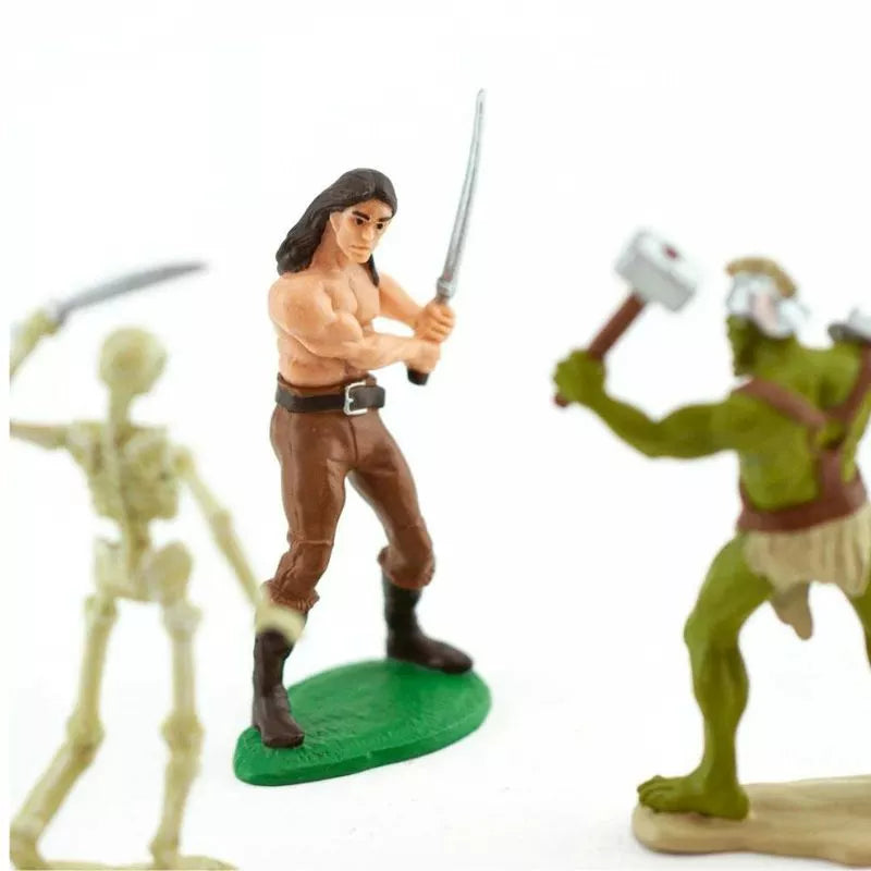 A group of TOOBS® Figurines Heroes & Monsters, engaging in creative play with swords and skeletons.