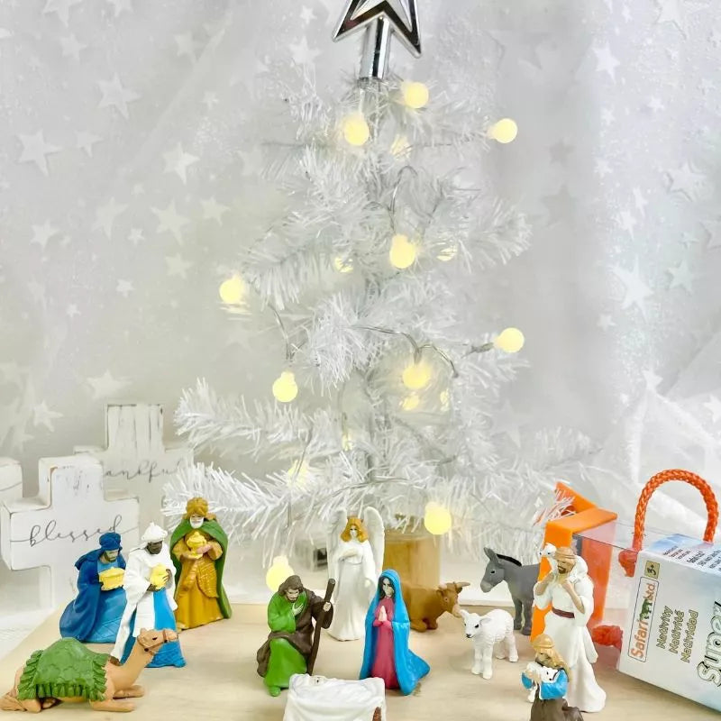 A TOOBS® Figurines Nativity with a Christmas tree.
