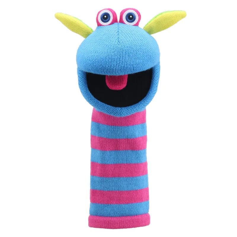 The Puppet Company Sockette Puppet Scorch is a vibrant knitted puppet adorned with blue, pink, and yellow stripes. It features a big smiling mouth, a protruding pink tongue with a squeaker inside, large googly eyes, and two yellow protrusions on top of its head that resemble ears or antennae.