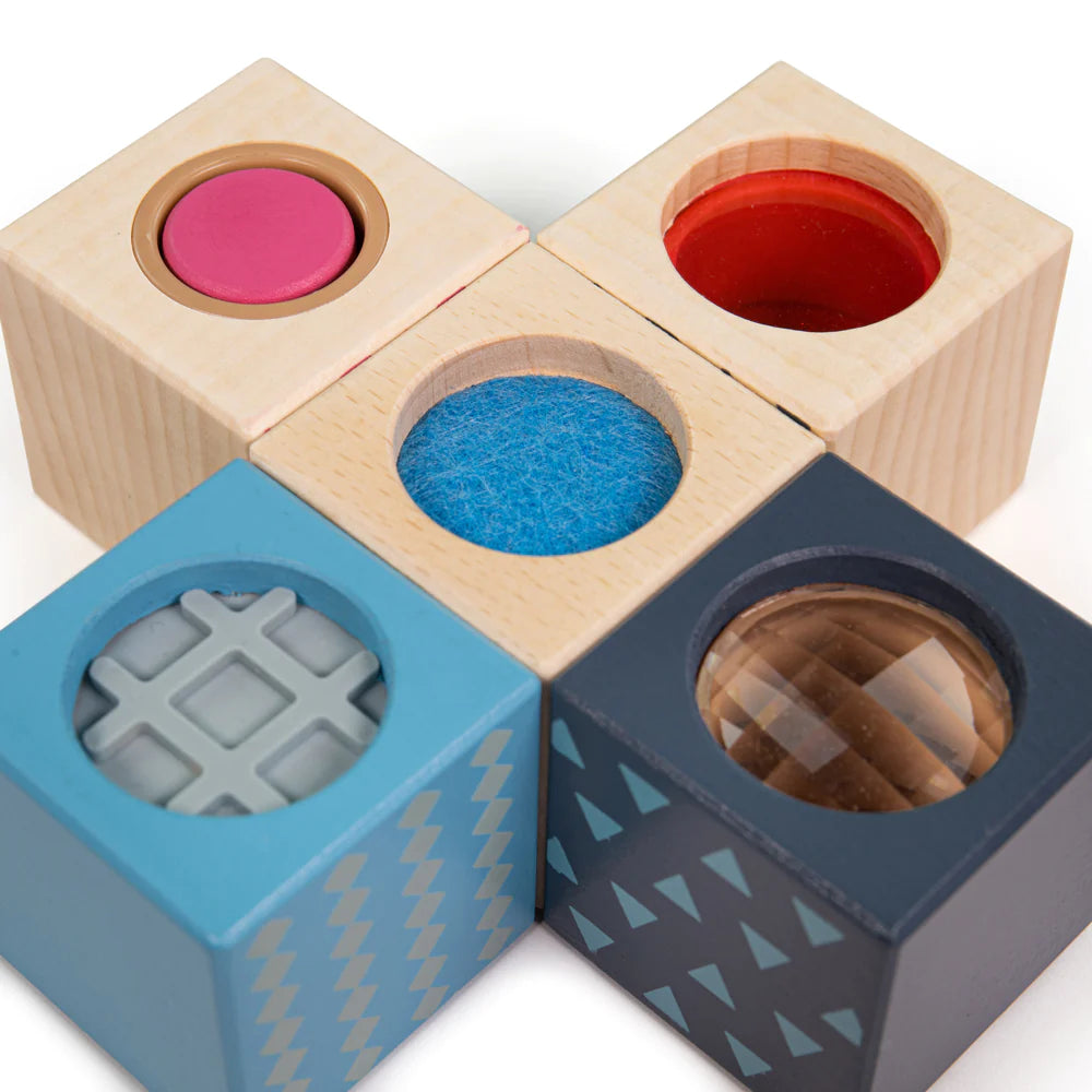 A group of four Bigjigs Sensory Blocks with different shapes.