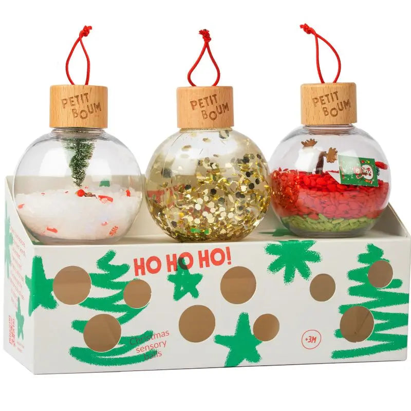 Christmas Sensory Baubles: three unbreakable, baby-safe ornaments with wooden caps in a “HO HO HO!” box. Each features unique festive fillings—a snow-covered mini tree, gold glitter, or red-green decor.