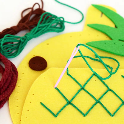 A close up of Bag Sewing Kit Pineapple on a piece of felt.