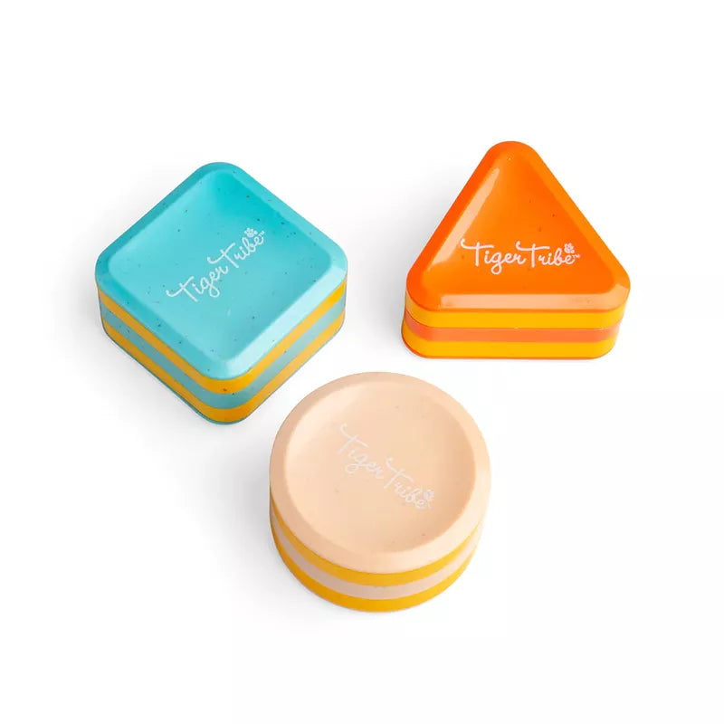 A set of three Shape Shakers sustainable toy containers on a white surface.