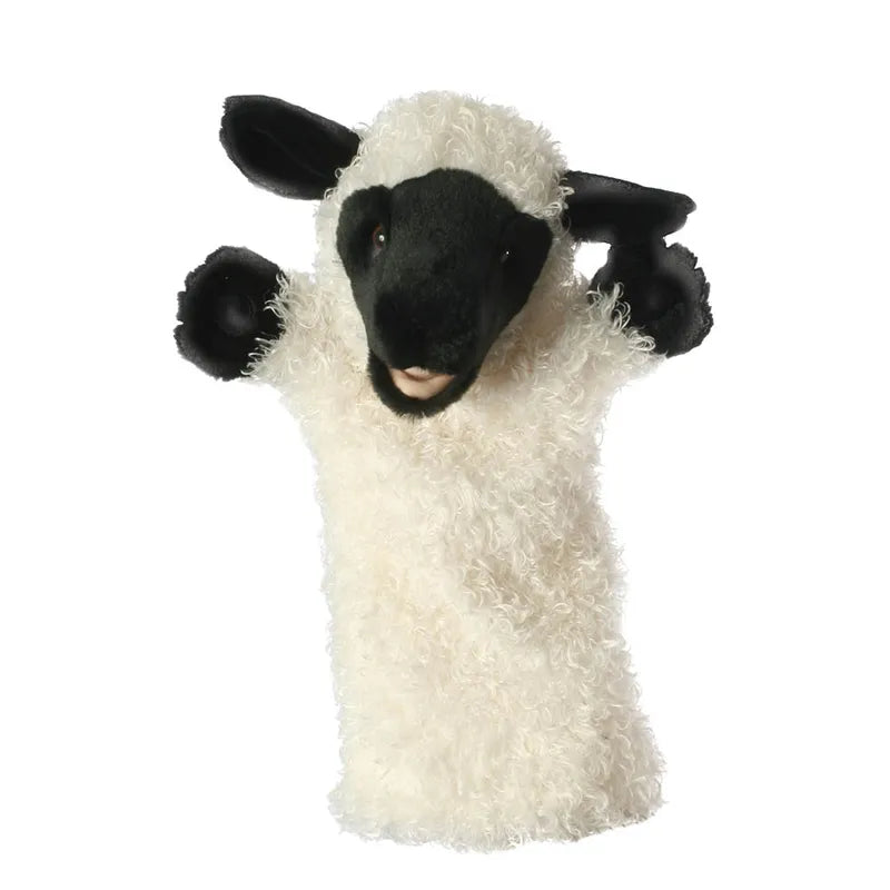 The Puppet Company Long Sleeved Puppet Sheep features a hand puppet that resembles a sheep with a white curly body and black face, ears, and feet. This friendly-looking sheep glove puppet has its mouth slightly open as if speaking or singing, making it perfect for encouraging creative play for any child interested in farm animals.