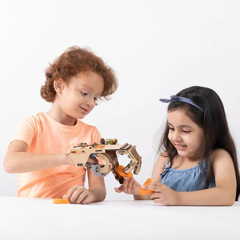 A girl and boy playing with a Smartivity STEM Construction Mechanical Hand while following an instruction manual.