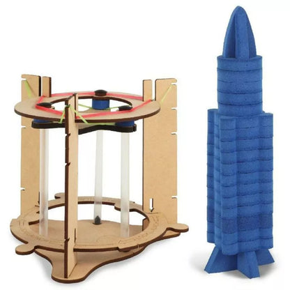 A blue plastic Smartivity Rocket Launcher and a model Smartivity Rocket Launcher are positioned next to each other on a launch pad.