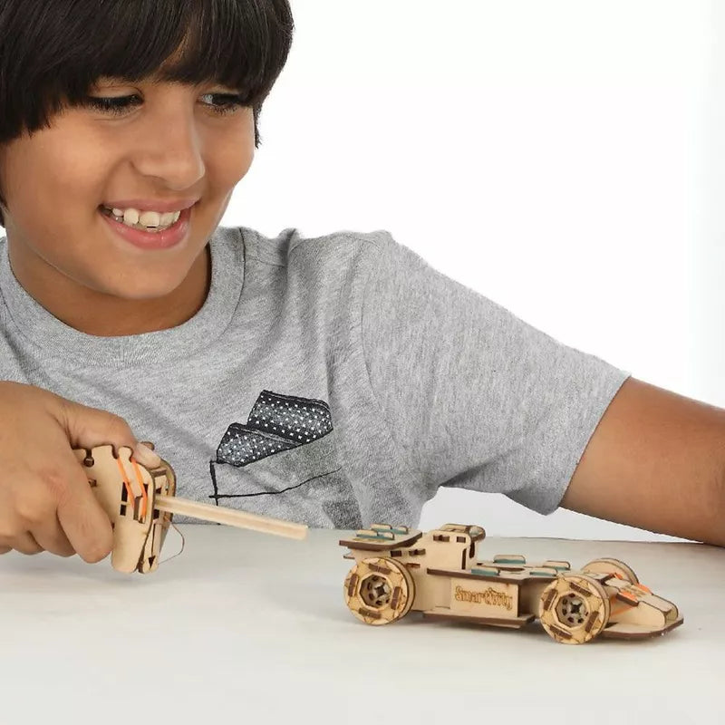 A young boy playing with a Smartivity Speedster toy.