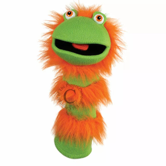 A colourful Sock Puppet named Sockette Puppet Ginger It’s knitted body is green and orange. It has big expressive eyes and is mouth moving.
