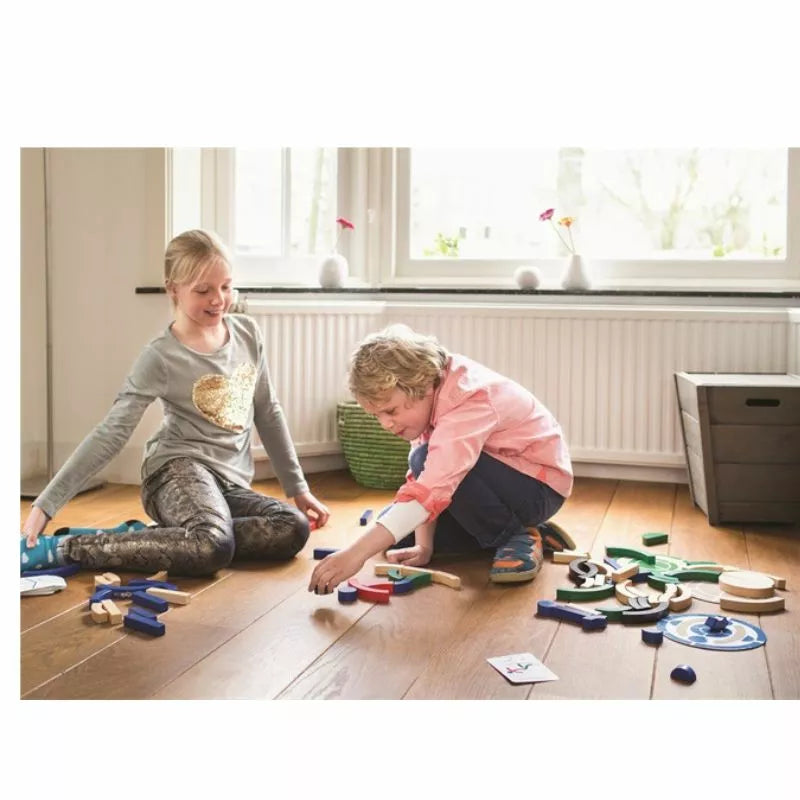 Two children playing with the Buitenspeel Sport Blocks Puzzle Game on the floor.
