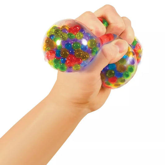 A hand squeezing a colorful Squeezy Peezy NeeDoh filled with beads.