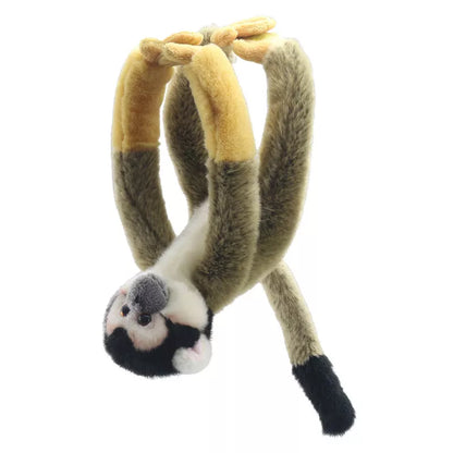 A plush toy of a Squirrel Monkey Canopy Climber hanging upside down, its tail and limbs creating a loop above its head, inspiring creative play.  