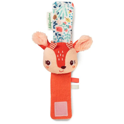 The Lilliputiens I'm Discovering Stella Bracelet Rattle is a soft, plush baby rattle shaped like a deer's head on a fabric strap. It features a colorful floral pattern on one side, solid orange on the other, Velcro for securing, and small orange ears—a perfect birth present with its friendly embroidered face.