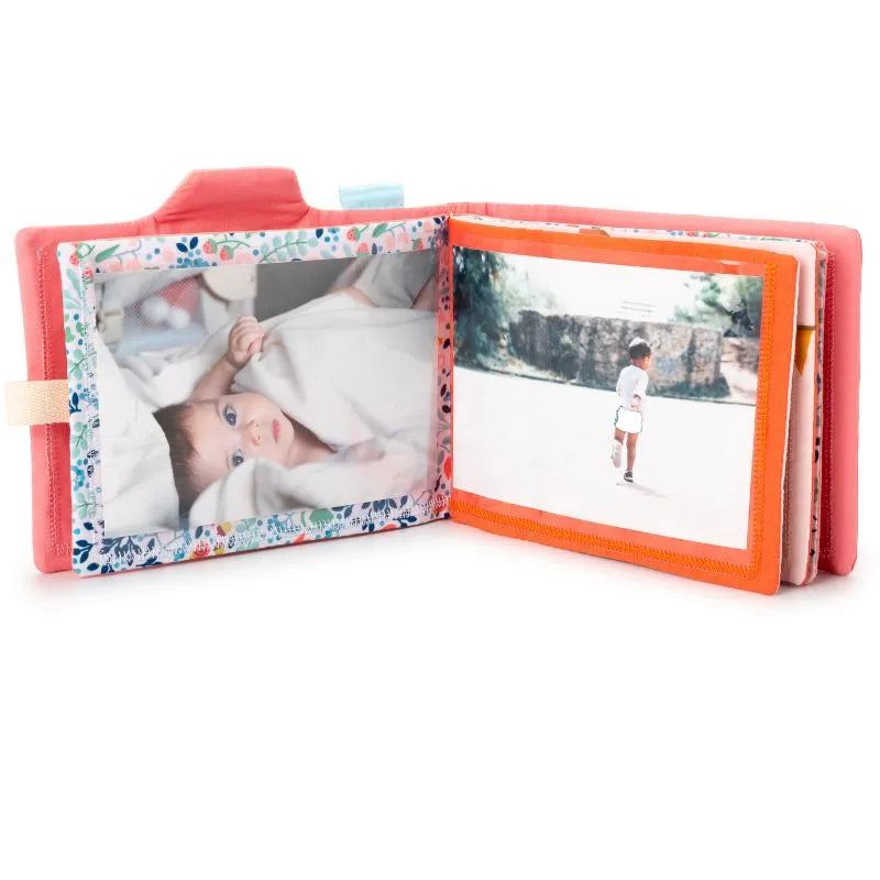 The Lilliputiens I'm Discovering Stella Photo Album features a textured pink cover, perfect for preserving cherished memories. Open to two pages, it displays a close-up of a baby under a blanket and a toddler outdoors, making it an ideal baby gift keepsake.