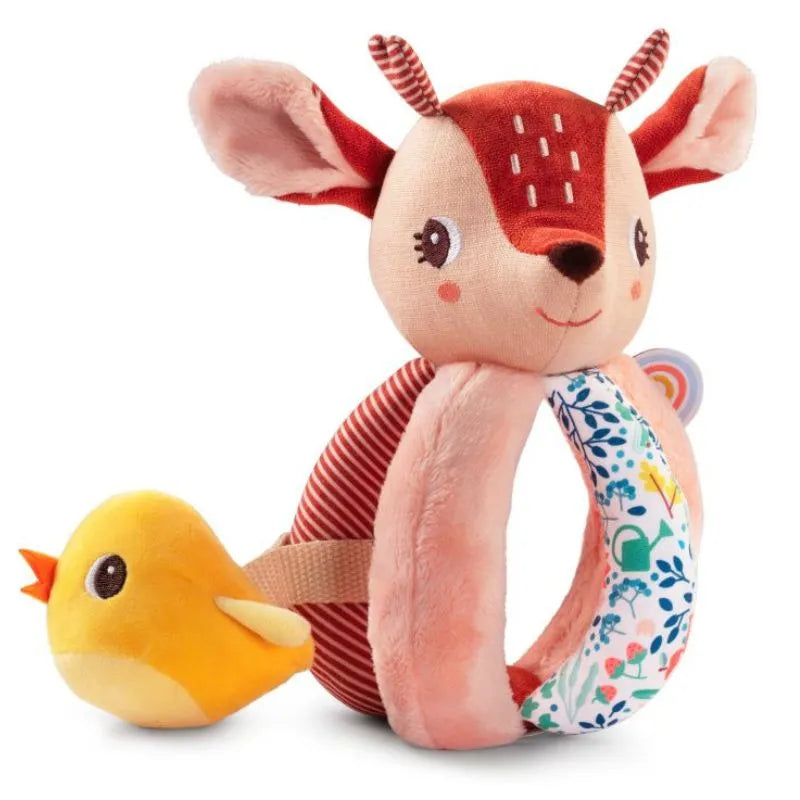 The Lilliputiens I'm Discovering Stella The Faon Rattle With Handles features a smiling deer adorned with red and pink details, textured handles, a ring with colorful plant and flower patterns, and a charming small yellow bird with an orange beak attached to the deer's side.