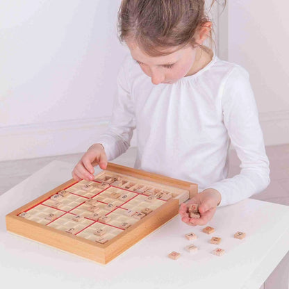 A little girl playing with the Bigjigs Sudoku Game.