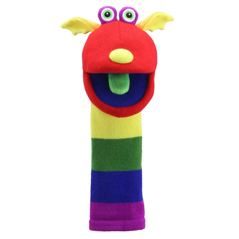 Introducing The Puppet Company Sockette Sunny: a vibrantly designed sock puppet featuring a red head, yellow ears, green eyes, and a long multicolored body with stripes of green, yellow, blue, and purple. The puppet's mouth is wide open to reveal a cheerful green tongue.