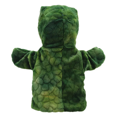 The "ECO Puppet Buddies T-Rex Hand Puppet" showcases a green dinosaur design, crafted from recycled materials, displayed from a rear view. This plush puppet features a textured body that mimics dinosaur scales, with a darker green stripe running down the center and lighter green patches on the sides. The head, arms, and facial expression are not visible in this view.