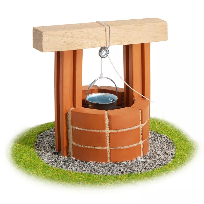 A Teifoc Brick Construction Waterwell, constructed using Teifoc cement and terracotta bricks, with a rope attached to it.