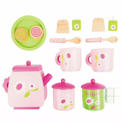 A tea set with kettle with pink and green accessories.
