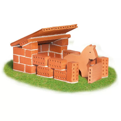 A Teifoc Brick Construction Horse Stable toy model of a horse inside a brick house.