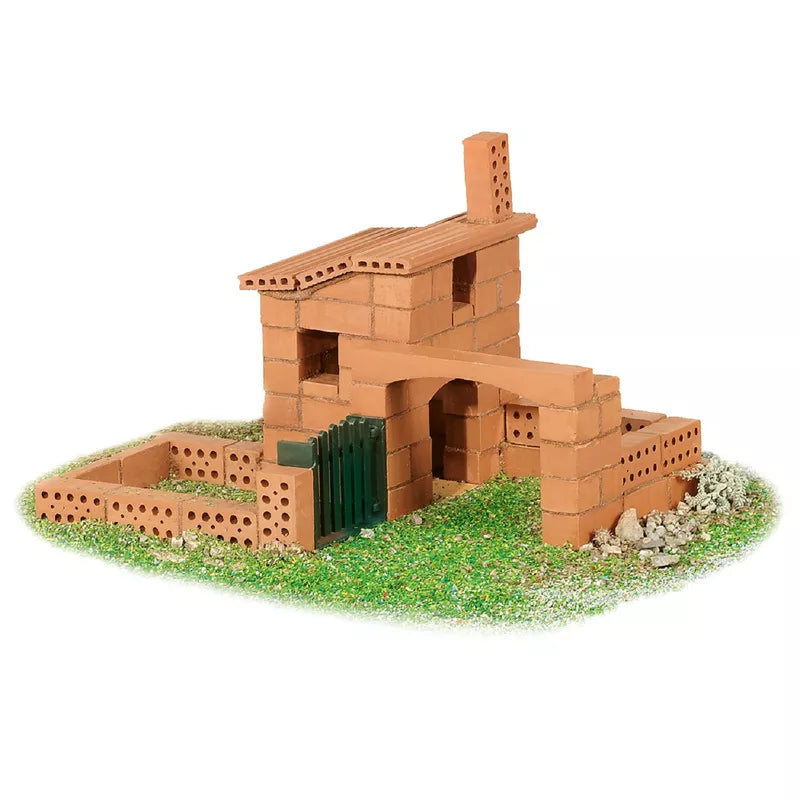 A model of a Teifoc Brick Construction - Small Cottage on a grassy surface.