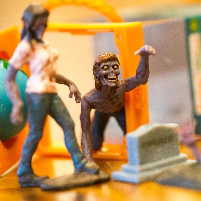 a group of TOOBS® Figurines Zombies on a table.