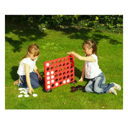 Two little girls playing with Giant Garden Game Four in a Row.