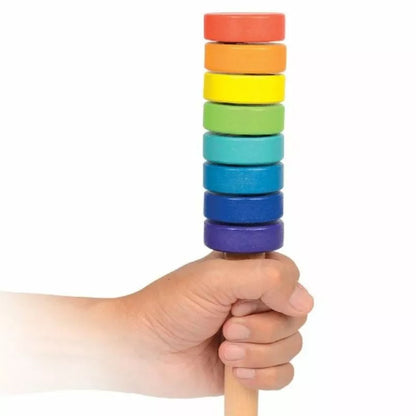 a hand holding a stack of SmartGames TrueBalance Compact (8 discs) wooden blocks.