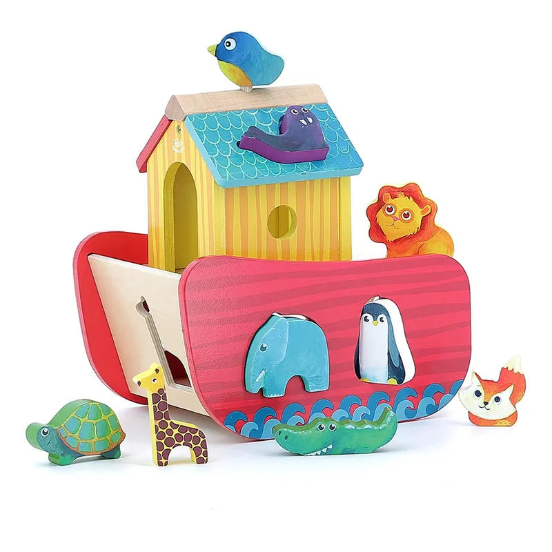 The Vilac Animals Ark Shape Sorter is a vibrant wooden toy that features slots for animal-shaped cutouts. Ideal for children aged 2 years and older, the ark's roof includes a charming blue bird, and it comes with animal pieces such as a lion, giraffe, turtle, elephant, penguin, crocodile, and fox. The base of the ark is adorned with painted waves.