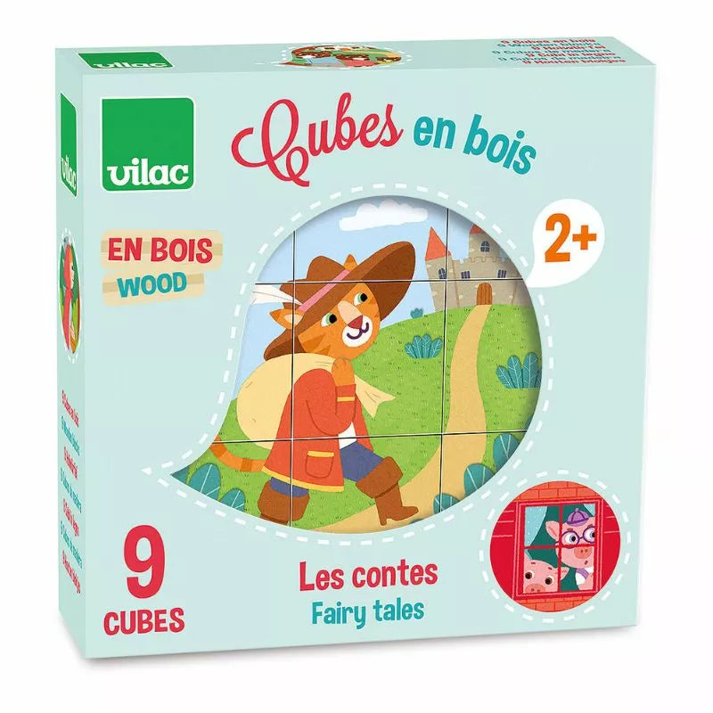 A boxed set of Vilac Wooden Blocks Tales, perfect as a fairy tales puzzle and toddler toy, is shown. The box indicates it's suitable for ages 2 and up and includes 9 blocks. The cover art displays a whimsical character in a hat and cape with a castle in the background.