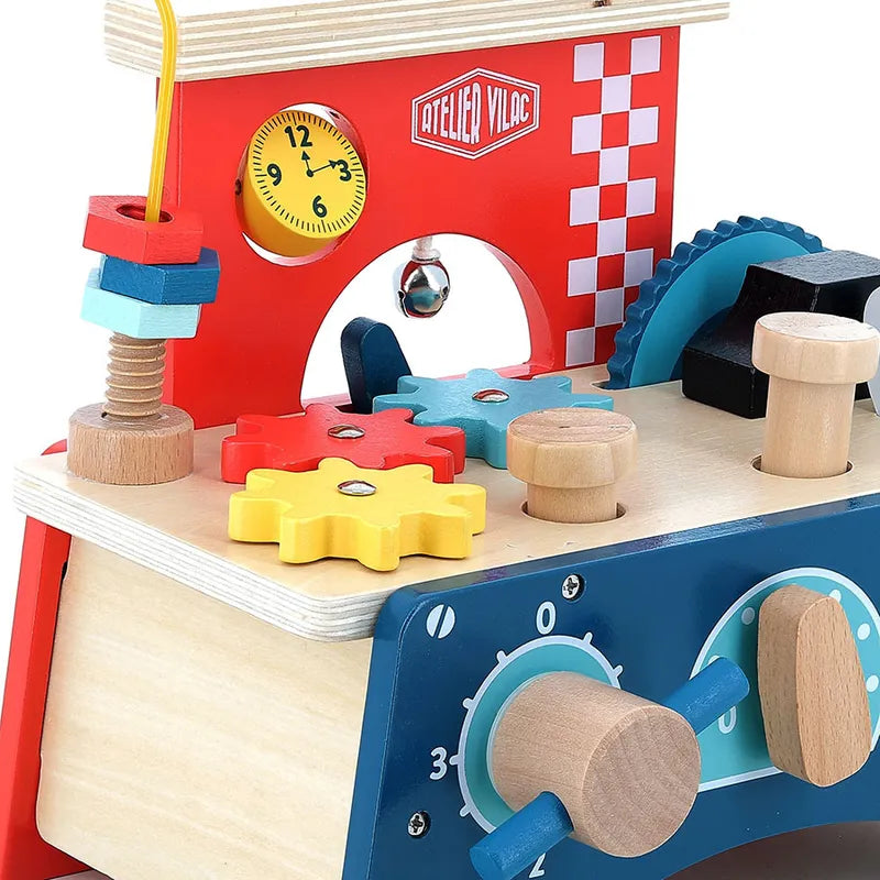 The Vilac Early Learning Workbench is a vibrant wooden toy intended for children aged 18 months and older. It includes a variety of interactive elements such as a clock, gears, knobs, and stacked shapes on a vertical rod. The background features a checkered pattern along with the words "Atelier Vilac," making it an engaging play-and-learn experience.