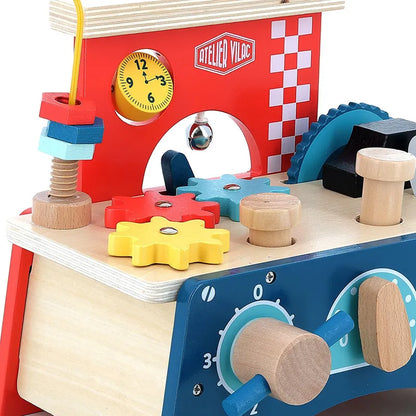 The Vilac Early Learning Workbench is a vibrant wooden toy intended for children aged 18 months and older. It includes a variety of interactive elements such as a clock, gears, knobs, and stacked shapes on a vertical rod. The background features a checkered pattern along with the words "Atelier Vilac," making it an engaging play-and-learn experience.