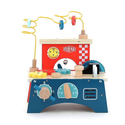 The Vilac Early Learning Workbench is a colorful wooden toy workbench for children 18 months and older, featuring various interactive elements including a clock, gears, levers, a bead maze, and a saw. The workbench is designed in blue, red, and yellow, complete with knobs and dials for pretend play.