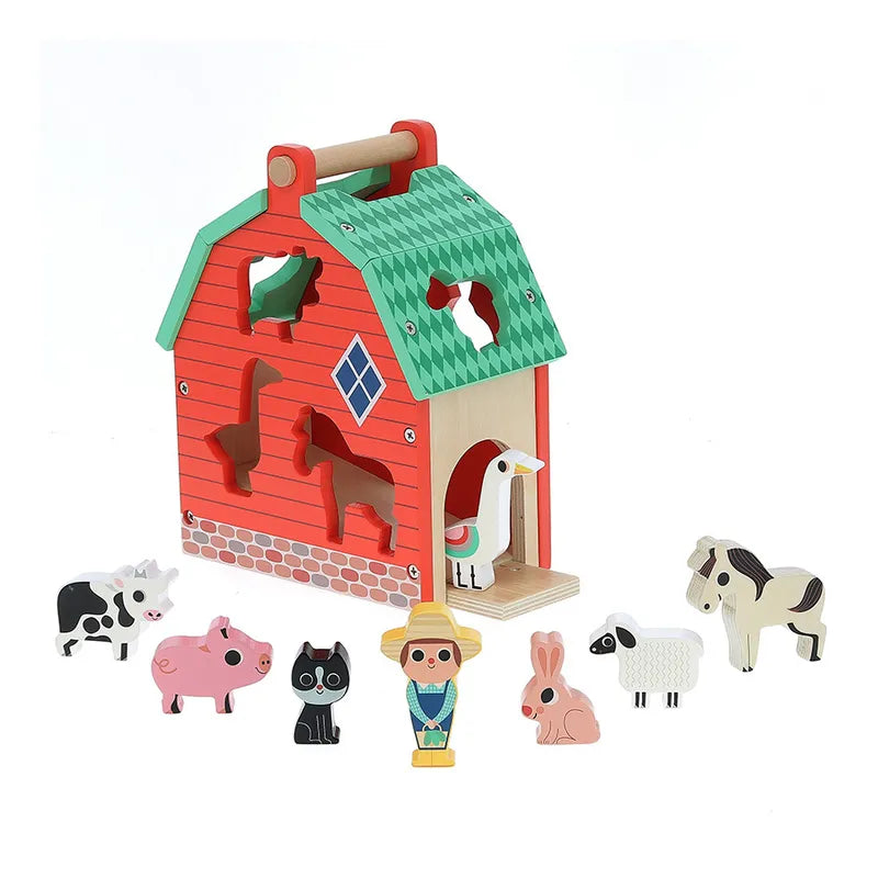 The Vilac My Nice Farm Shape Sorter is a wooden red barn toy with a green roof that features animal-shaped cutouts. Surrounding the barn are 10 pieces: a cow, pig, cat, farmer, duck, horse, dog, sheep, rabbit, and chicken. Ideal for toddlers aged 2 years and up, this wooden toy allows shapes to be inserted into their corresponding cutouts in the barn.