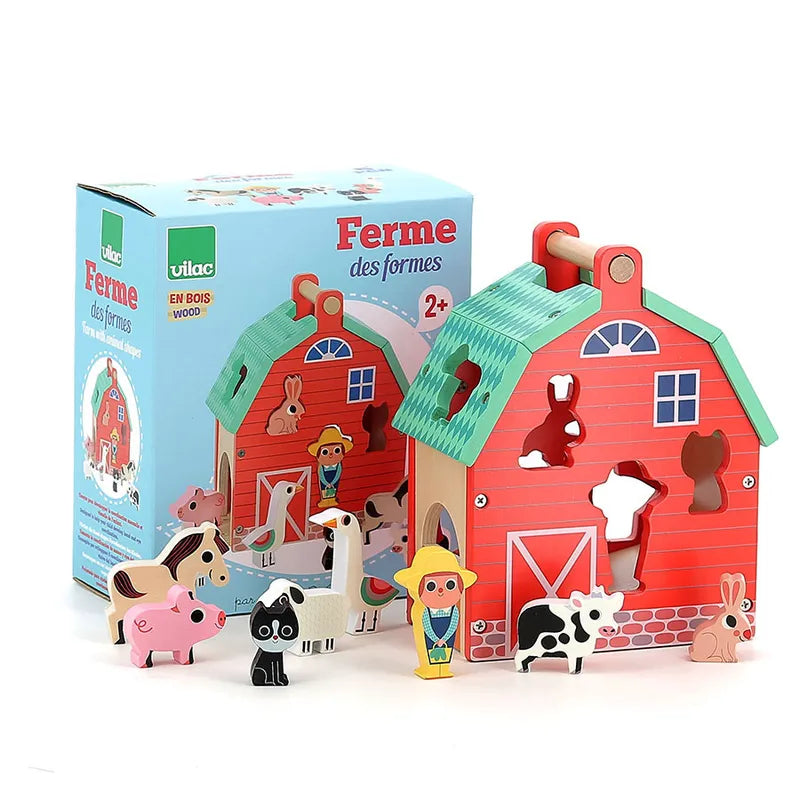 The Vilac My Nice Farm Shape Sorter is a vibrant wooden barn-shaped toy featuring a blue roof and various animal-shaped cutouts, ideal for toddlers aged 2 years. The set includes wooden animal figures such as a cow, pig, rabbit, cat, and more, all arranged in front of the barn alongside its packaging box.