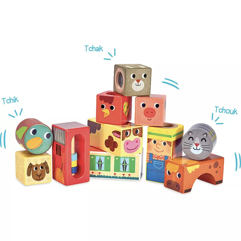 a stack of Vilac Farm Musical Blocks with animals and words on them.