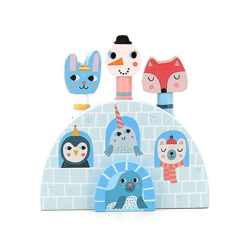 Introducing the Vilac Pop-Up Iceland: a vibrant wooden toy designed for children aged 18 months and older. This delightful toy features charming animal characters such as a bunny, seal, fox, and other marine creatures popping out of an iceberg-like structure in blue and white hues. Each character is adorned with small, cheerful details and accessories that enhance their playful appeal.