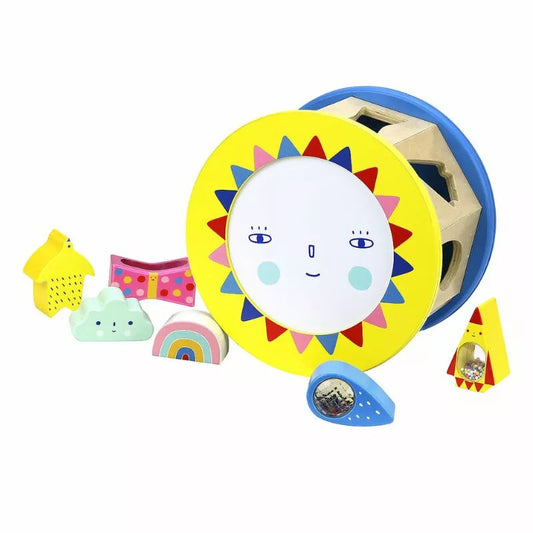 a Vilac Night and Day Shape Sorter toy with a face and other toys.