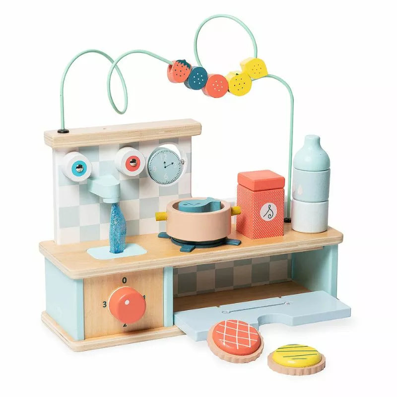 a Vilac Multi-activity Early-Learning Kitchen with various items on it.