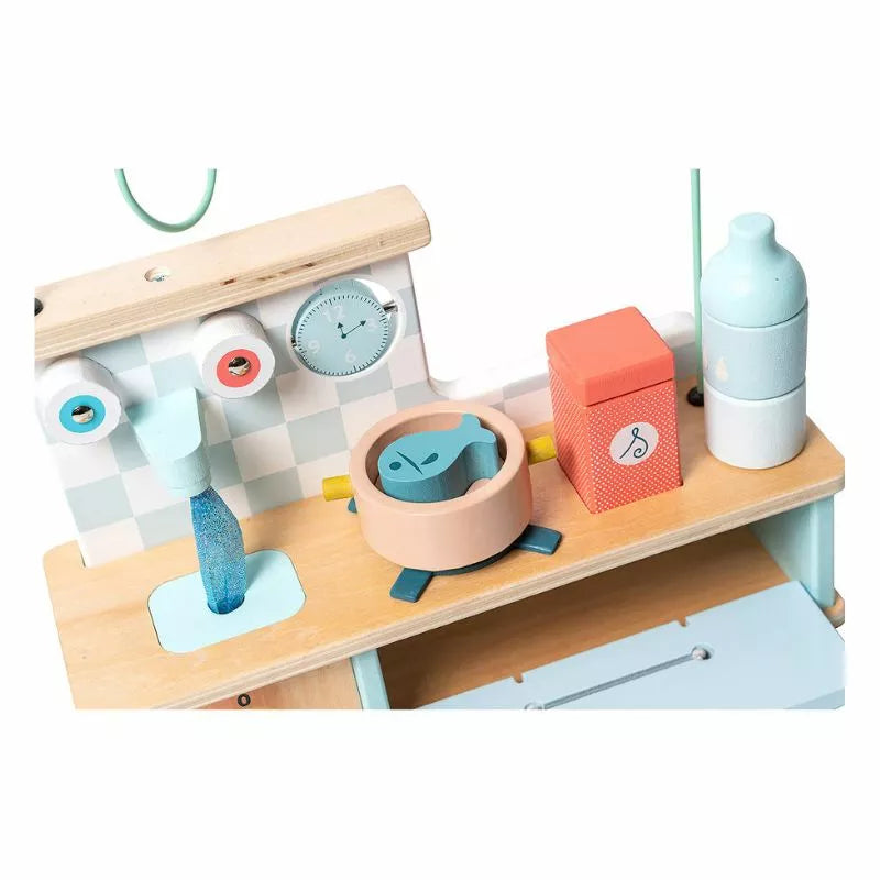 A Vilac Multi-activity Early-Learning Kitchen with various items on it.