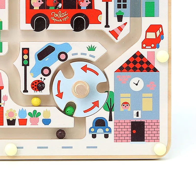 The Vilac My Little Town Magnetic Maze is a vibrant children's wooden toy featuring illustrations of vehicles, buildings, and people. This playful maze includes pathways with various obstacles and turntables for marbles to navigate around, making it an ideal toy for 2-year-olds.