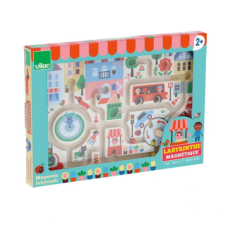 The Vilac My Little Town Magnetic Maze, suitable for children aged 2 and up, is an engaging wooden toy that features vibrant illustrations of a town. The box showcases cartoon images of people, animals, buildings, and vehicles, along with the words "Labyrinthe Magnétique" and the Vilac logo.